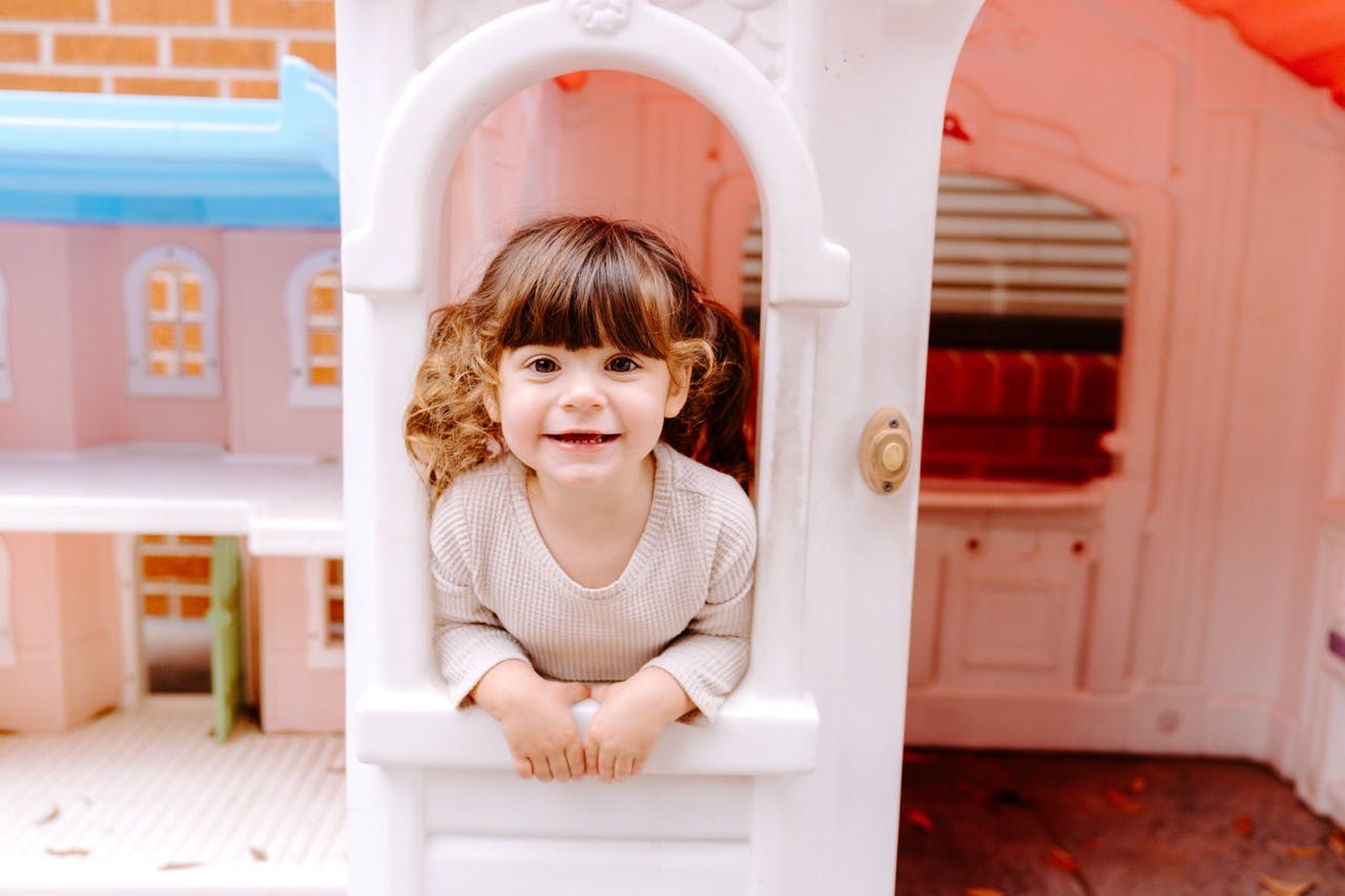 Child looking out of a playhouse window