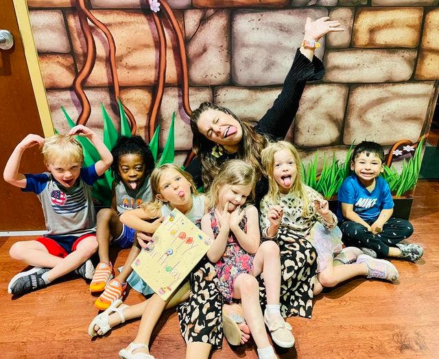 Adult and children making silly faces, sticking out tongues
