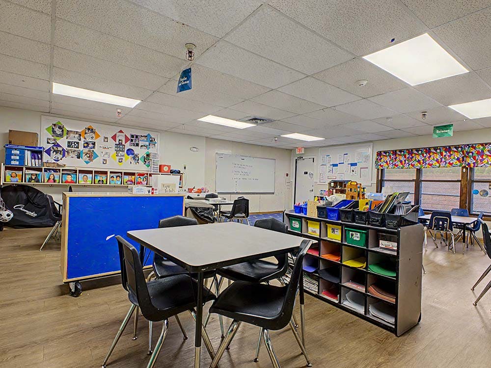 Classroom with tables, chairs, and learning materials