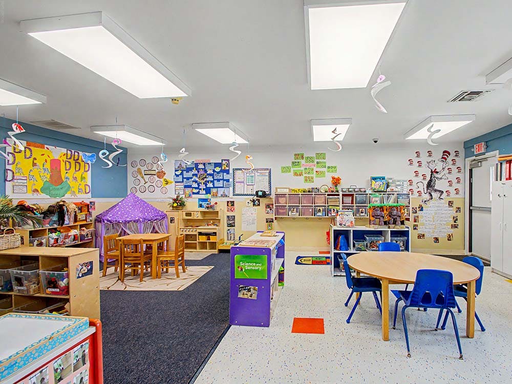 Classroom with tables, chairs, and play areas