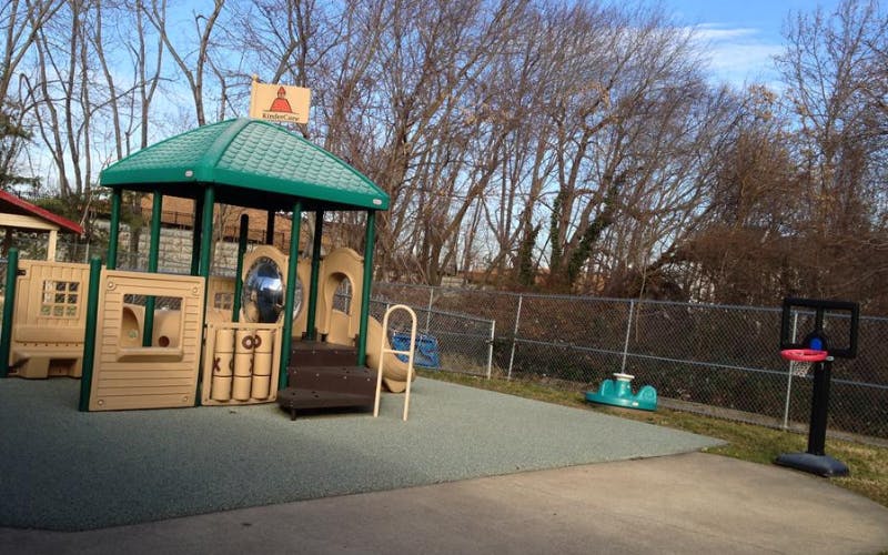 Empty playground with a play structure and basketball hoop