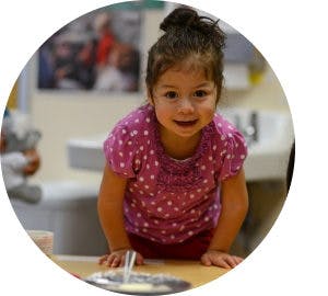 Child leaning on a table