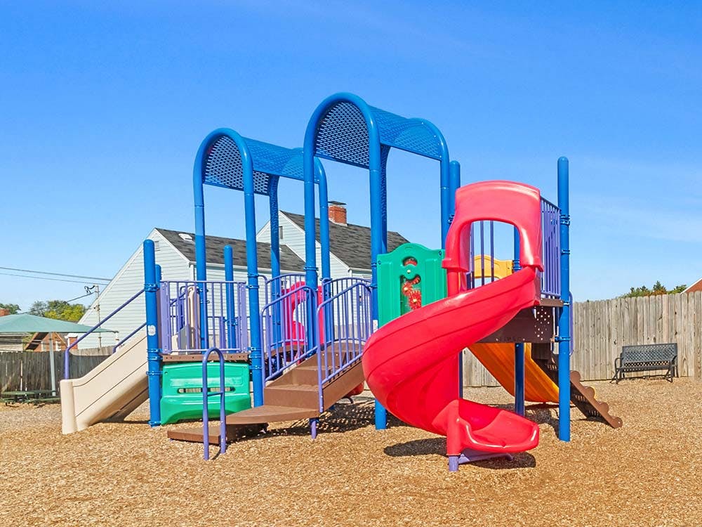 Colorful playground with multiple slides and climbing structures