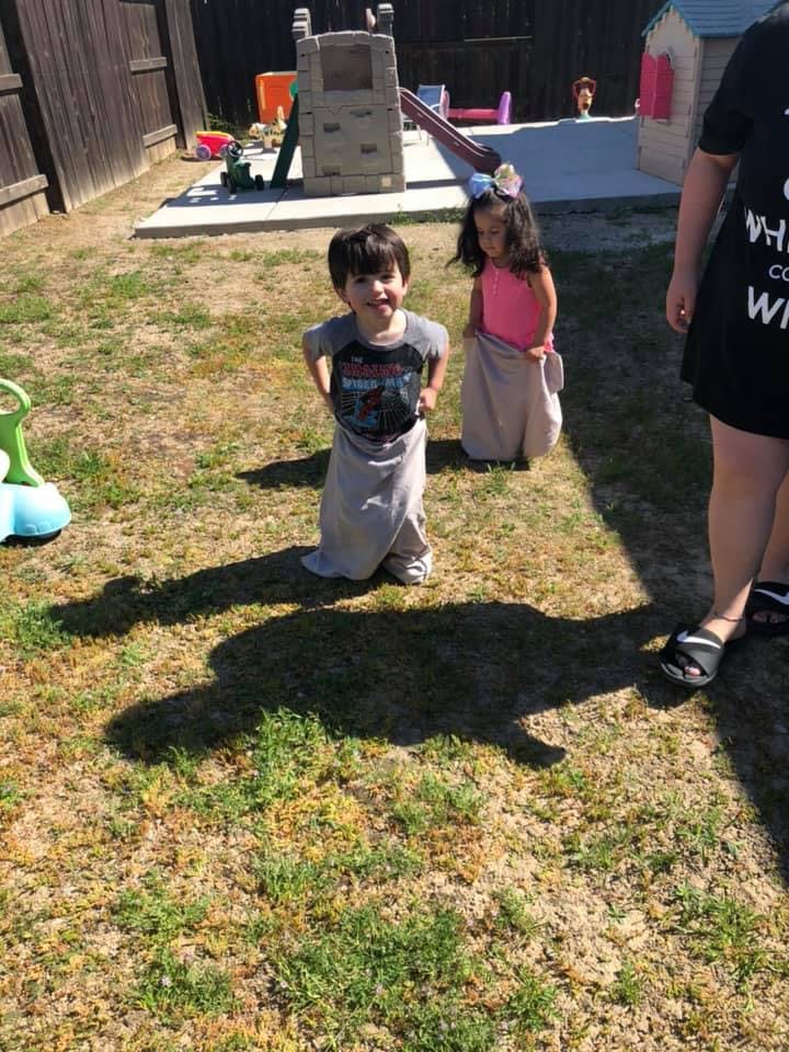 Two children in sacks for a sack race