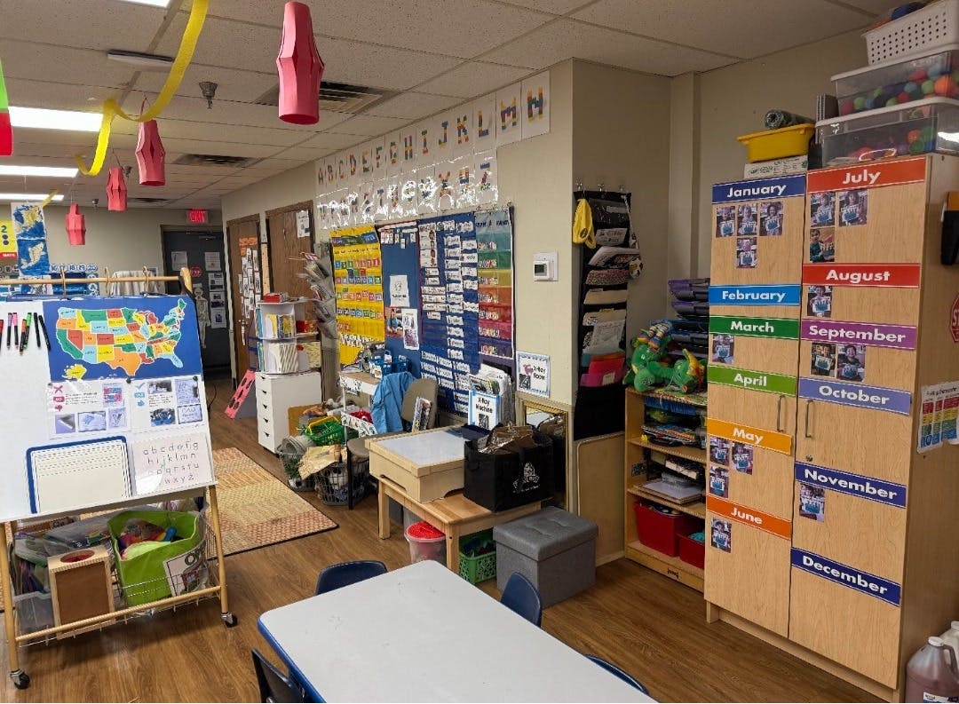 Colorful classroom with learning materials, alphabet, and a calendar with months