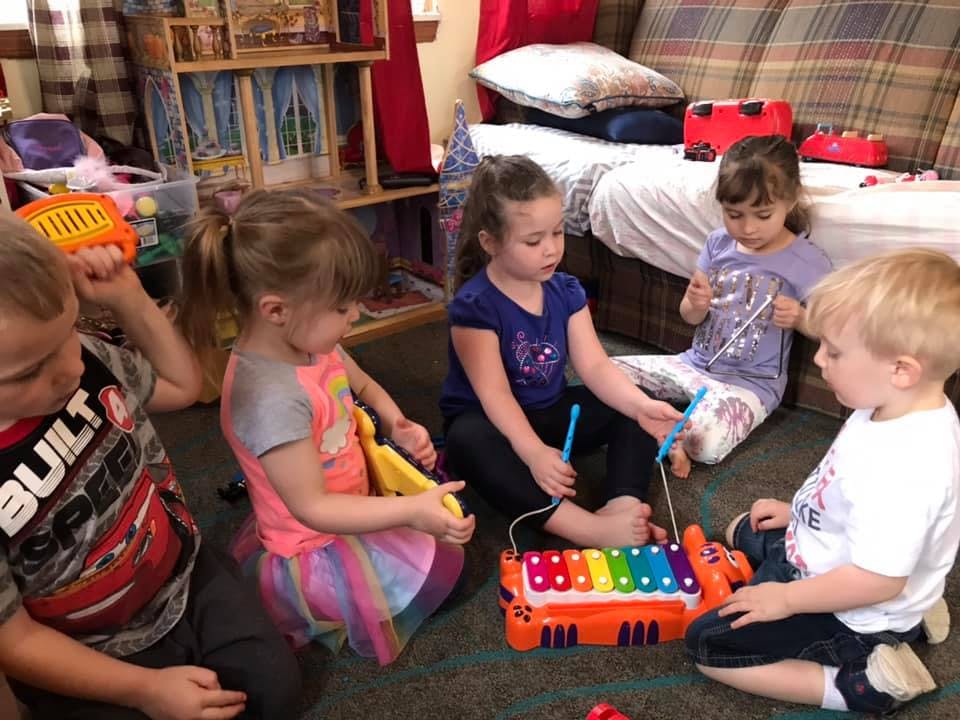 Children playing with musical toys on the floor