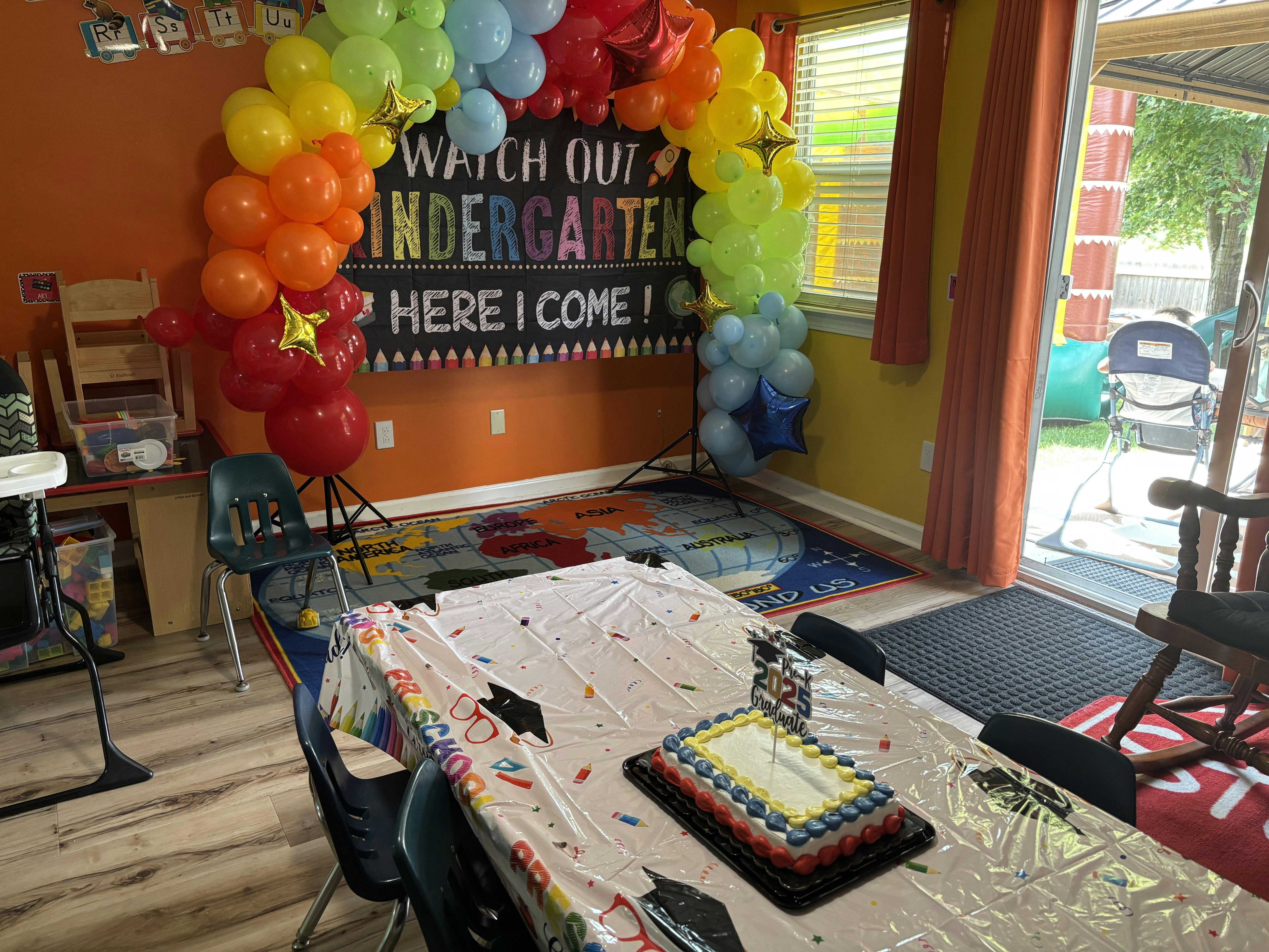 Table with a cake and a sign that reads "Watch out Kindergarten here I come"