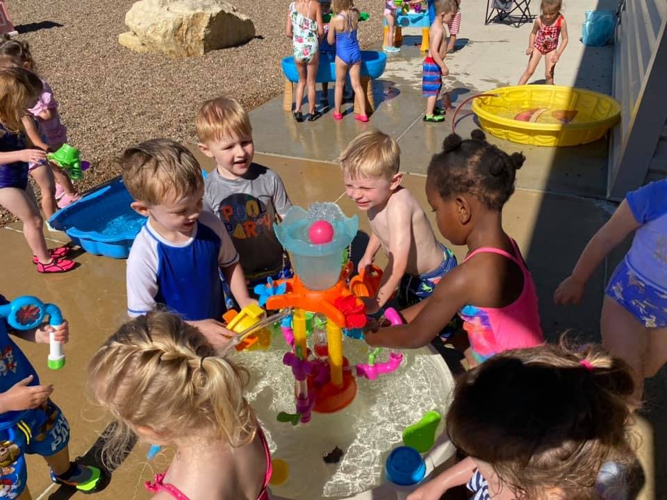 Children playing with water toys outdoors