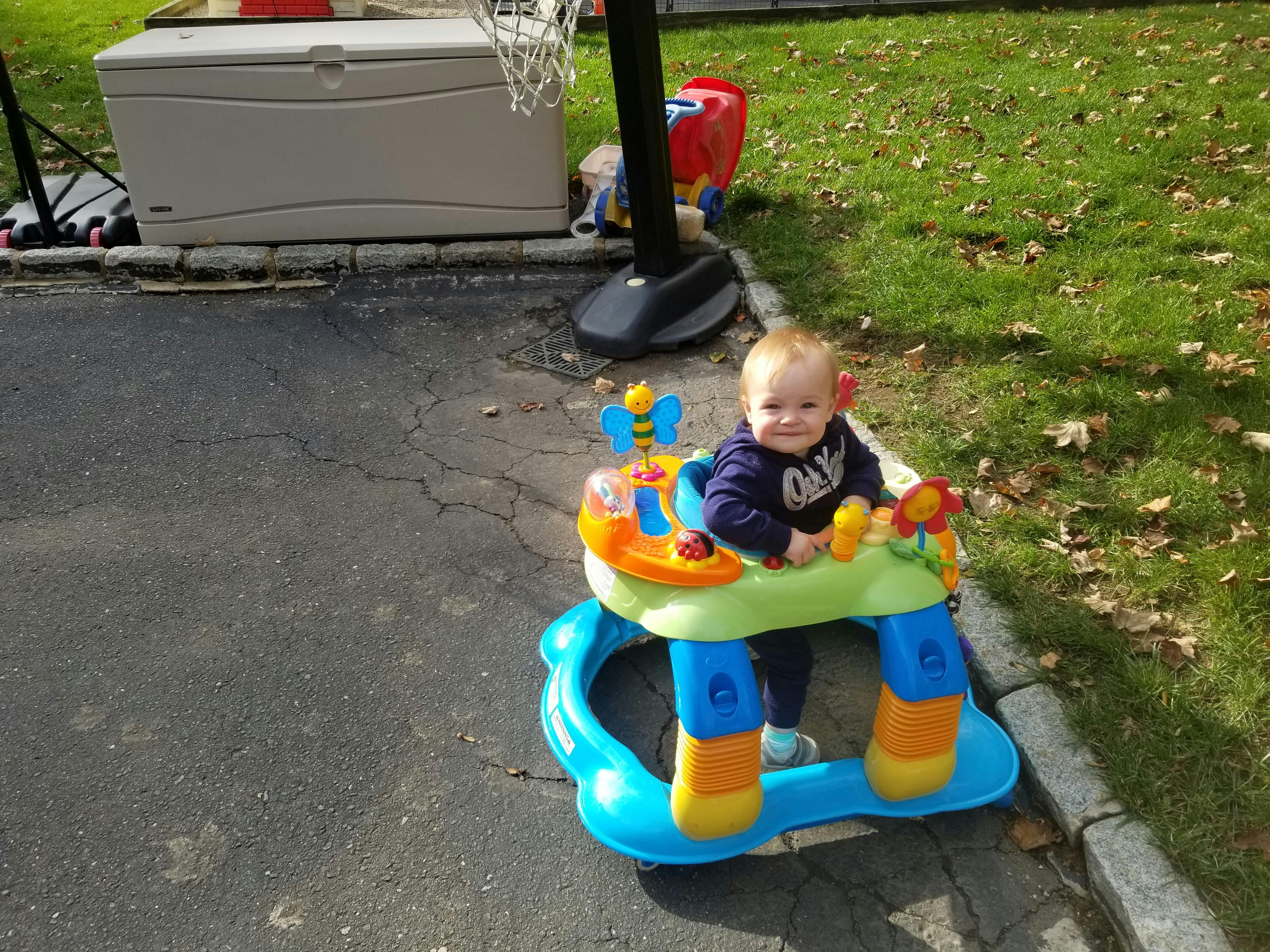 Child in a colorful baby walker outdoors
