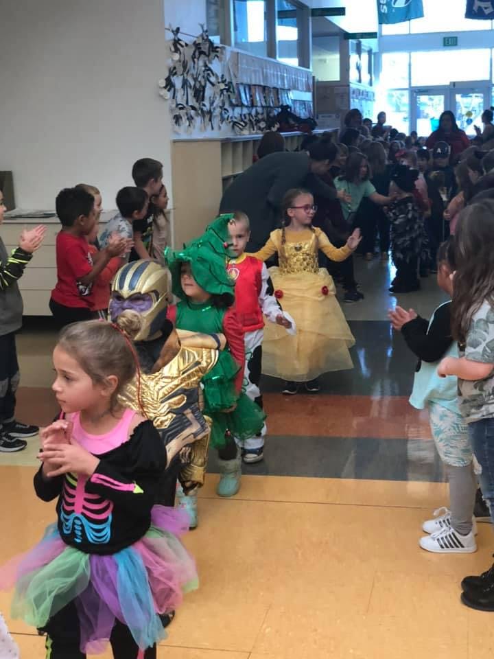 Children in costumes walking in a line