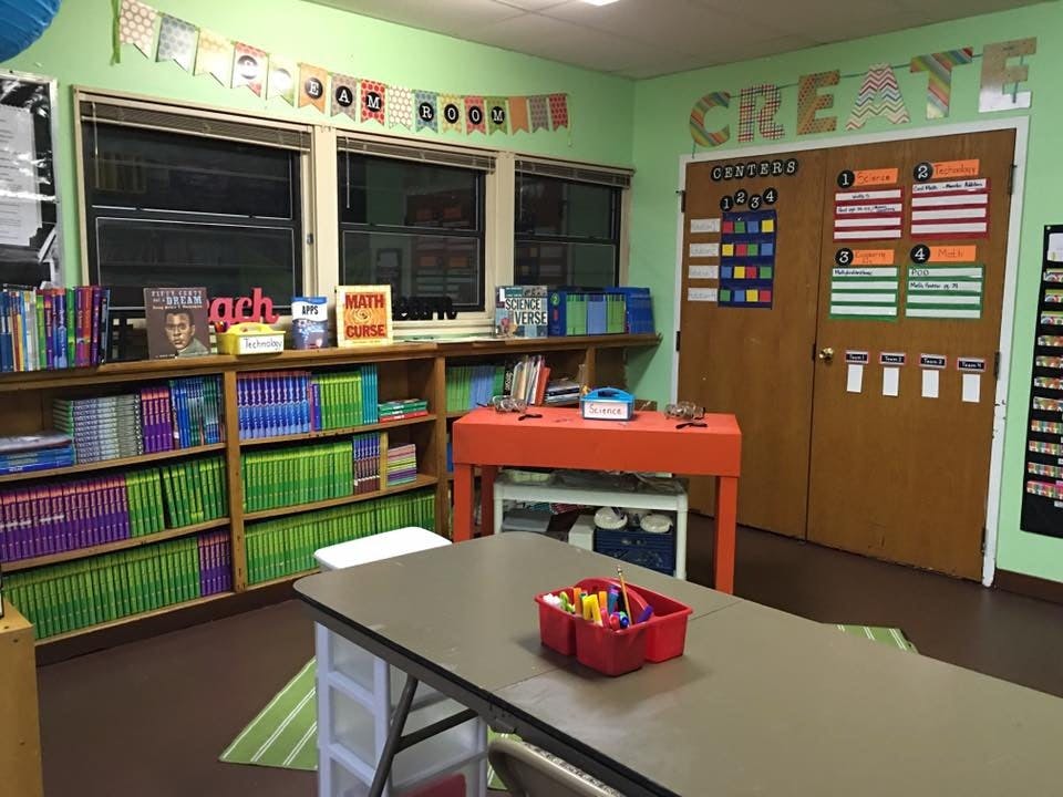 Classroom with bookshelves, tables, and decorated door