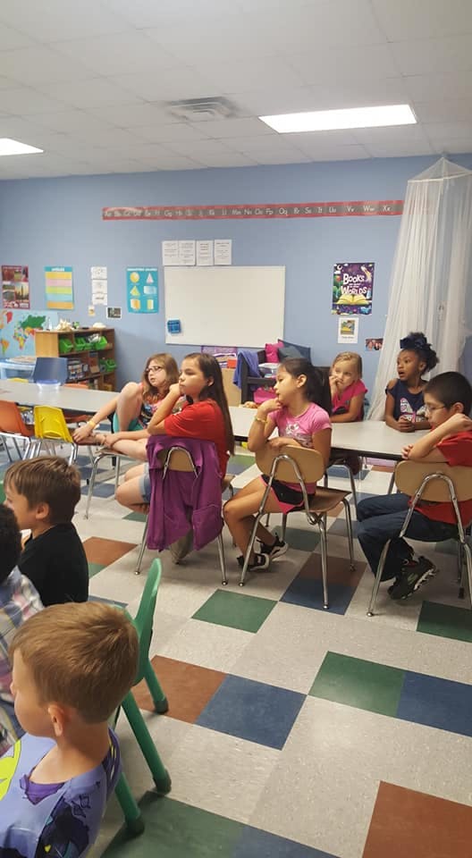 Children sitting at desks in a classroom
