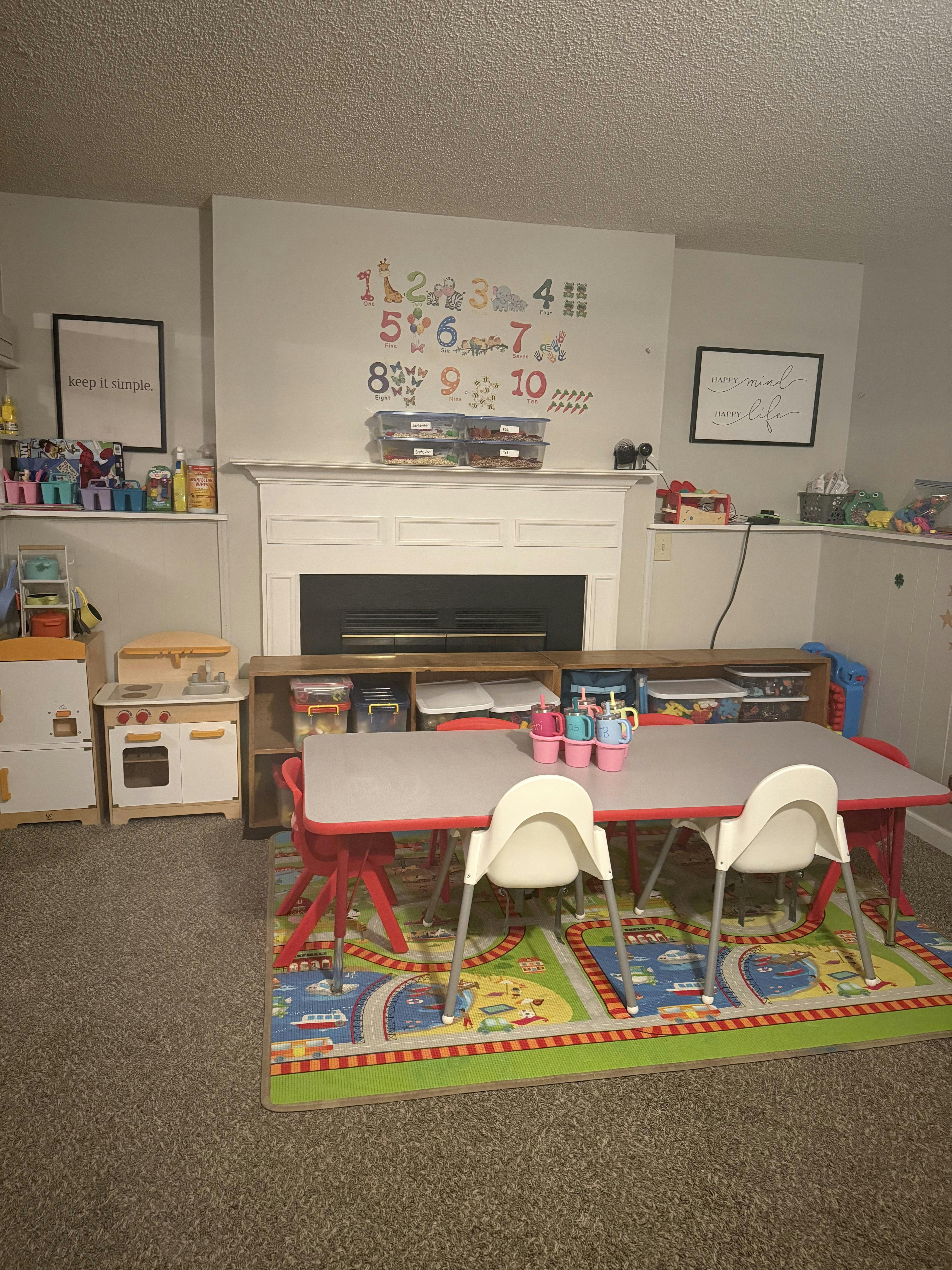 Children's play area with a table, chairs, and toy kitchen