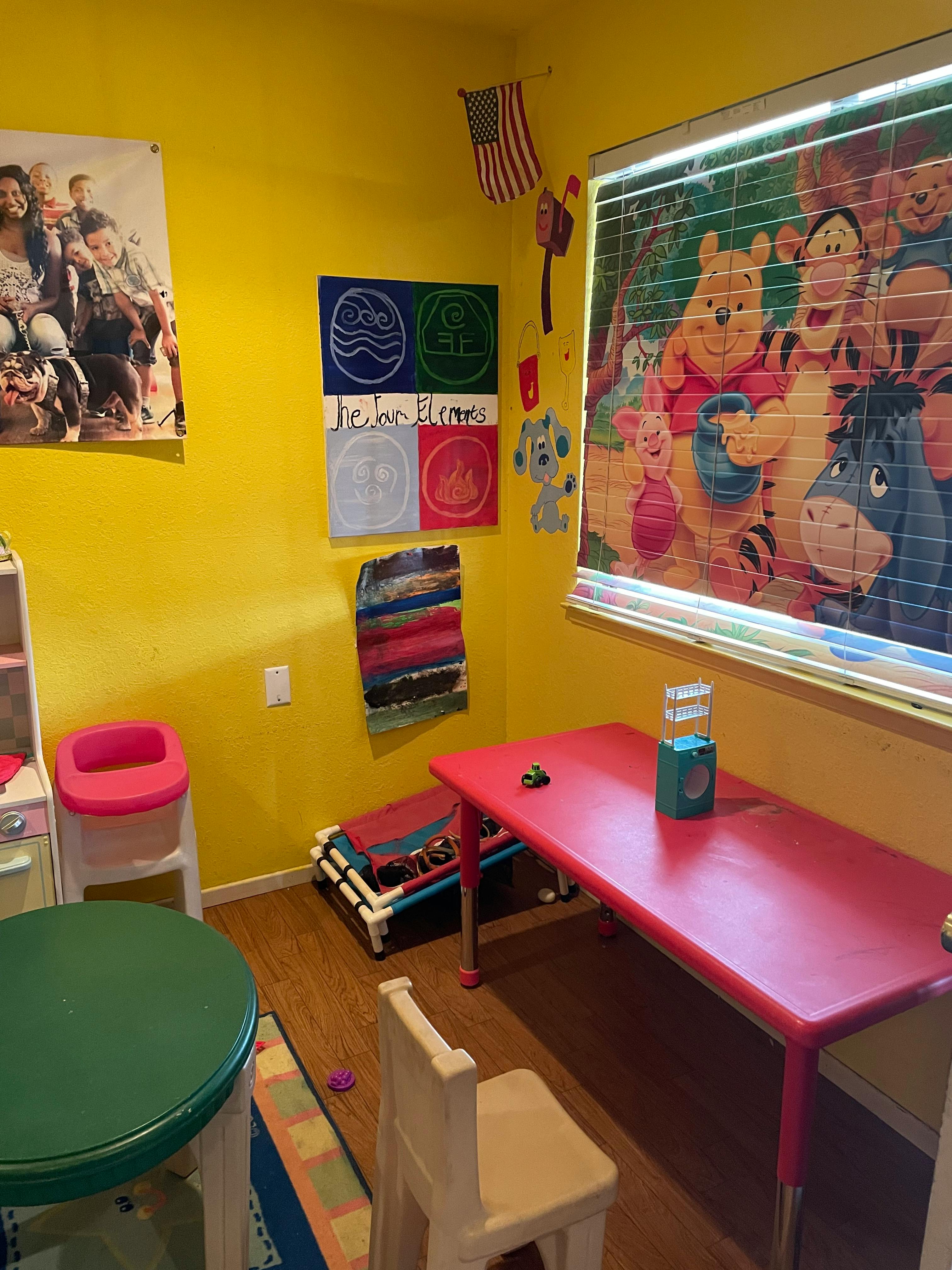 Children's play area with small tables and chairs, Winnie the Pooh blinds
