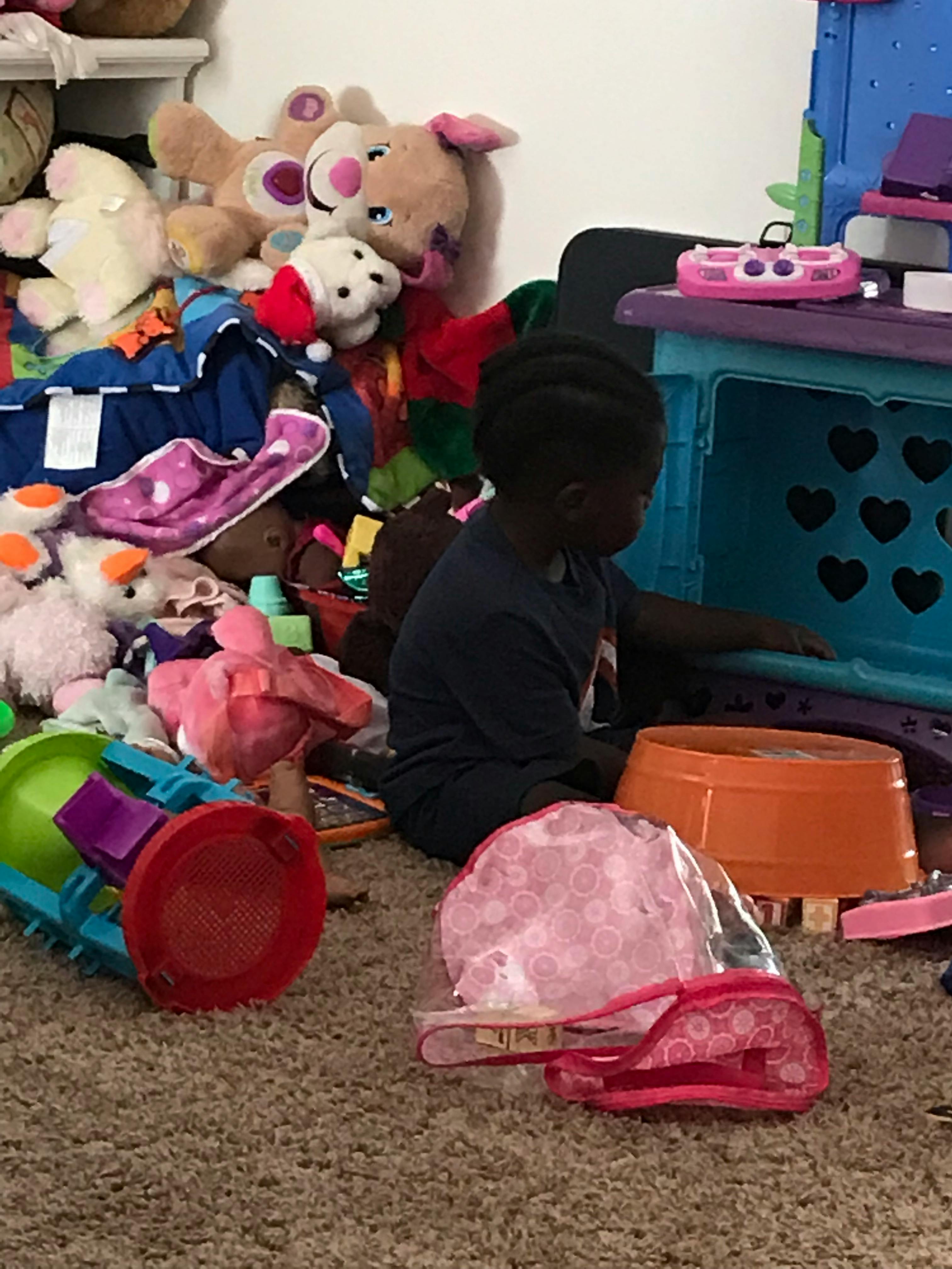 Child playing with toys on the floor
