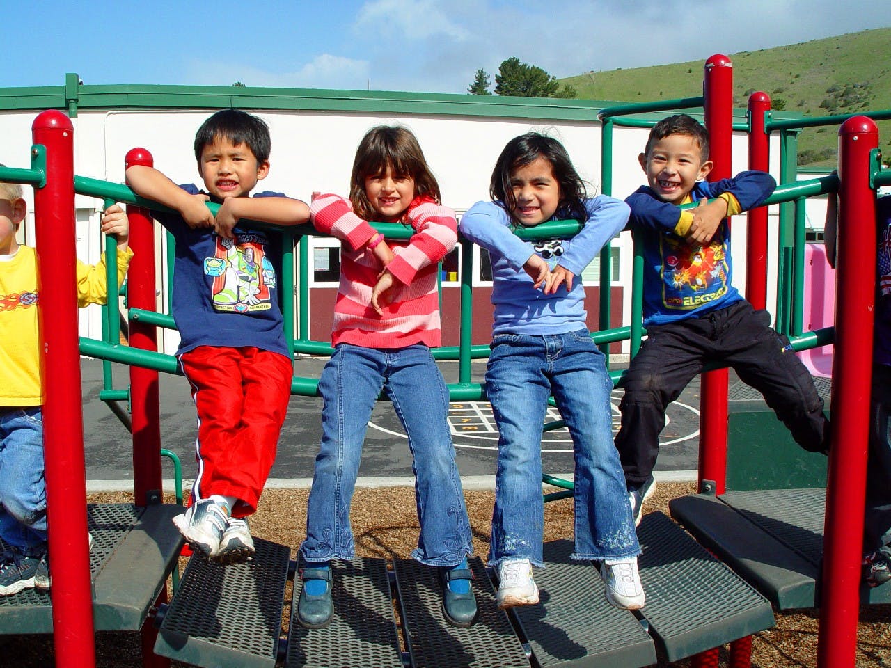 Four children on playground equipment
