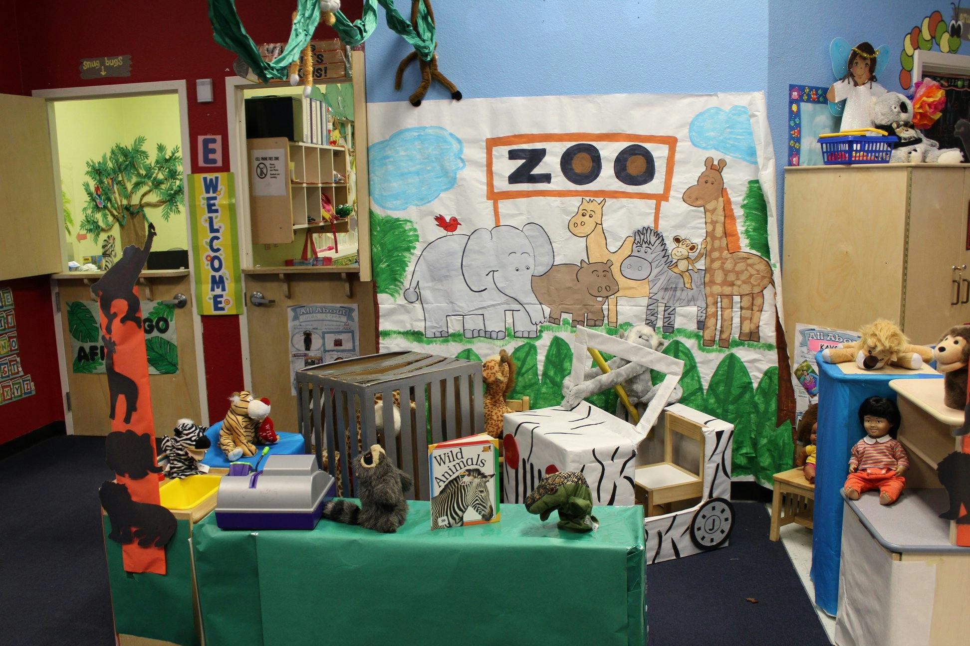 Playroom with a zoo-themed backdrop and animal toys