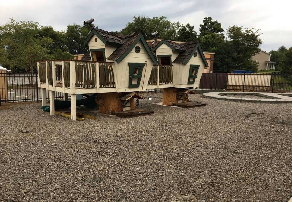 Playhouse with multiple gables and a deck