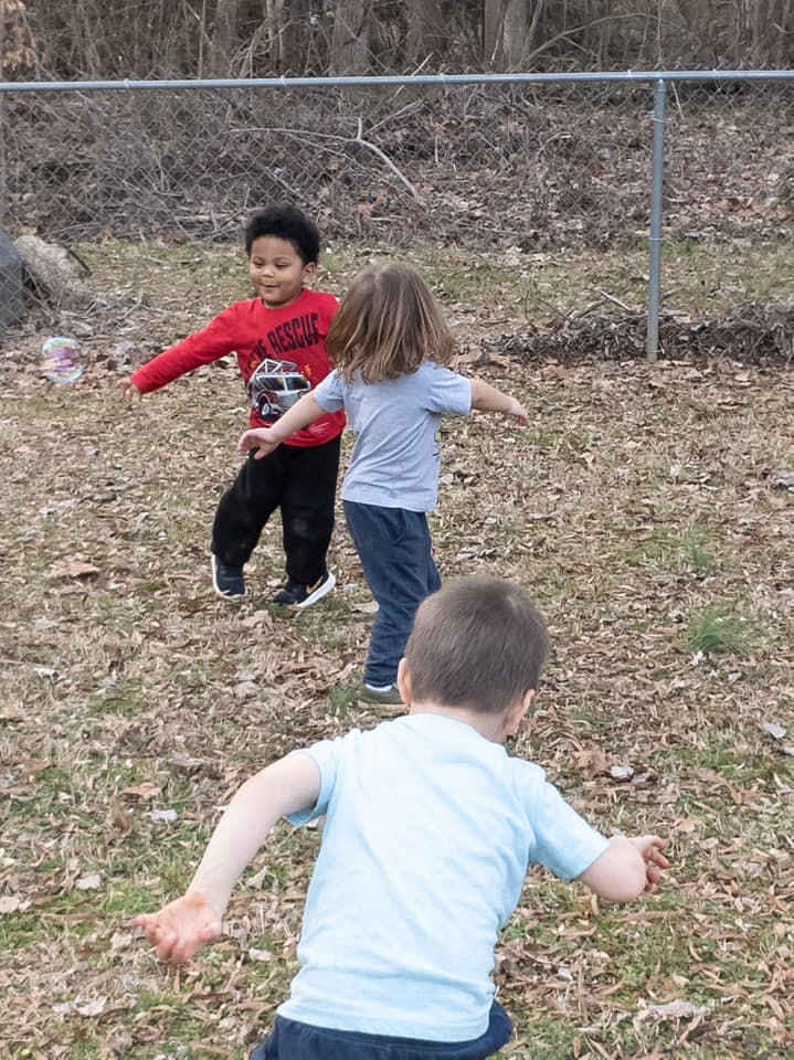 Three children playing outdoors