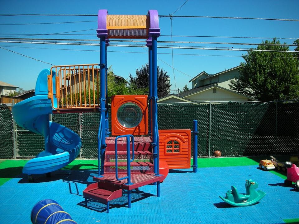 Playground with blue slide and orange climbing structure