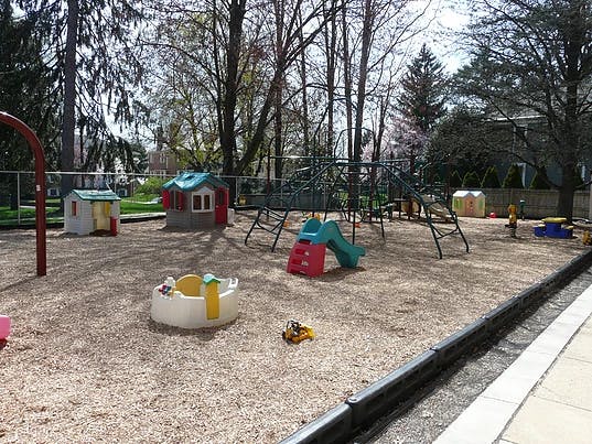 Playground with playhouses, slide, and climbing structure