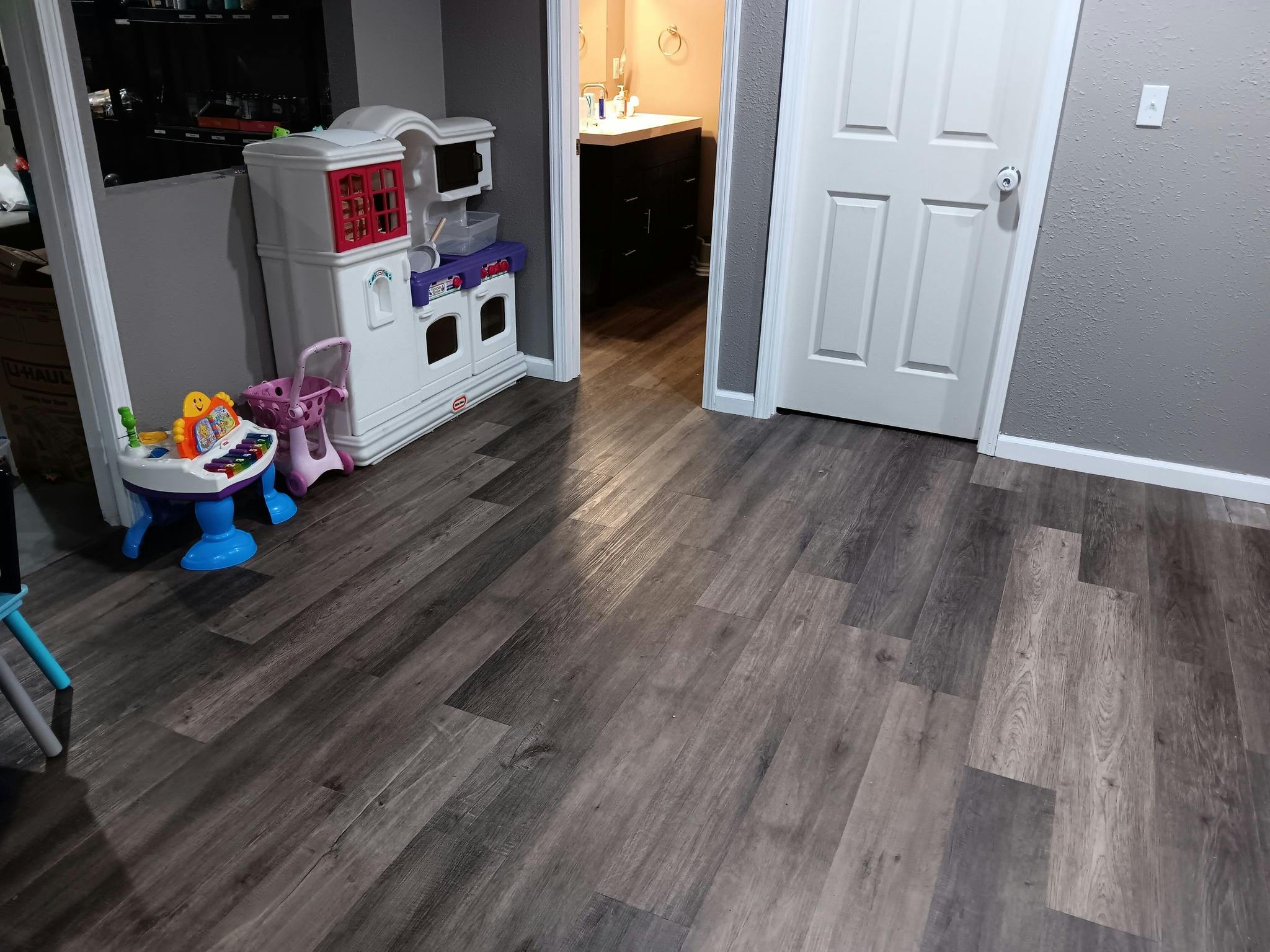 Hardwood floor with a toy kitchen and baby walker