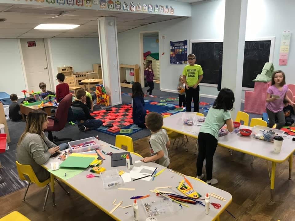 People and children in a classroom setting
