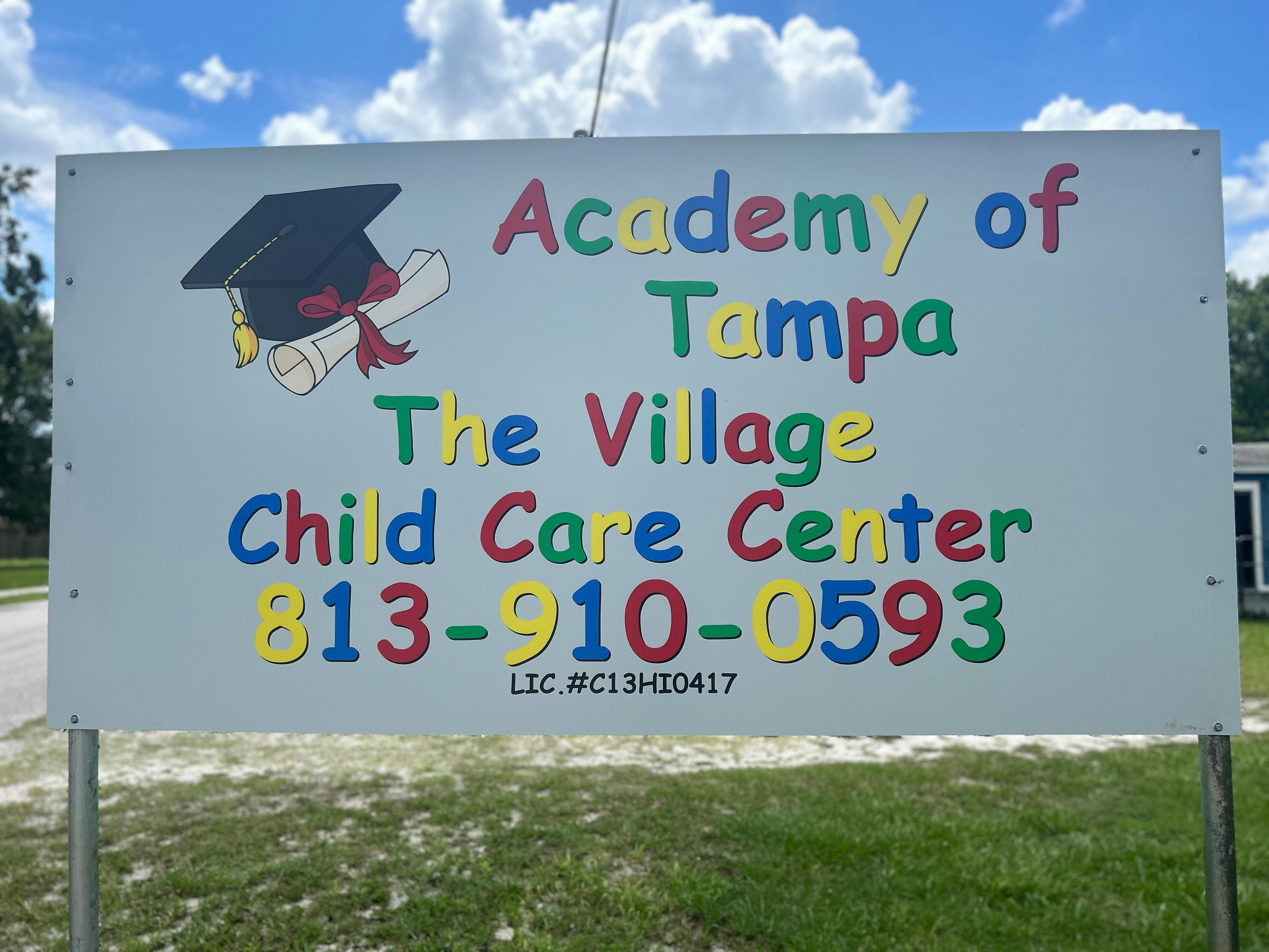 Sign for Academy of Tampa The Village Child Care Center with phone number