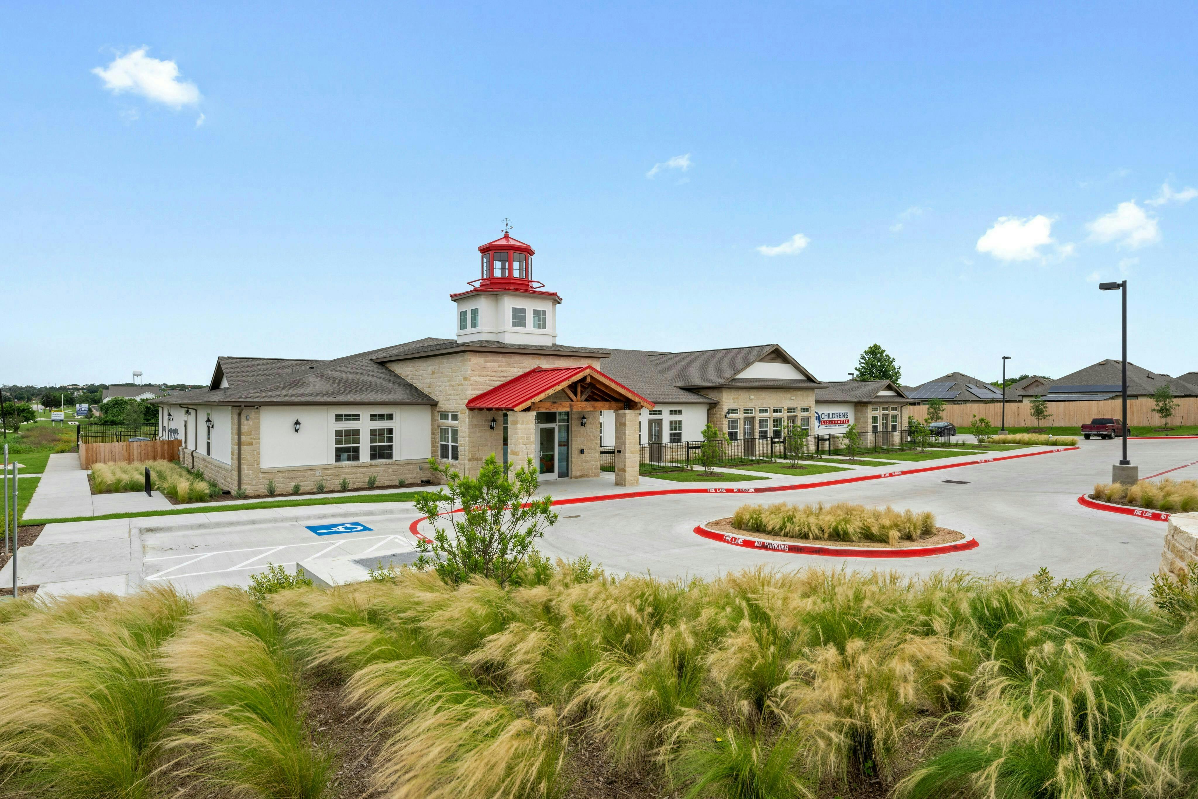 Building with a red roof and a white tower with a red top
