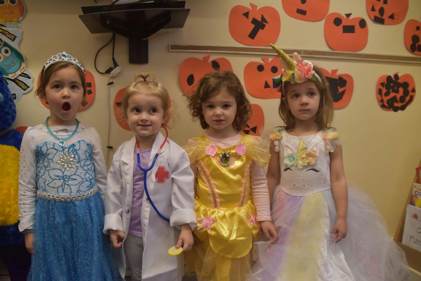 Four children in costumes standing together