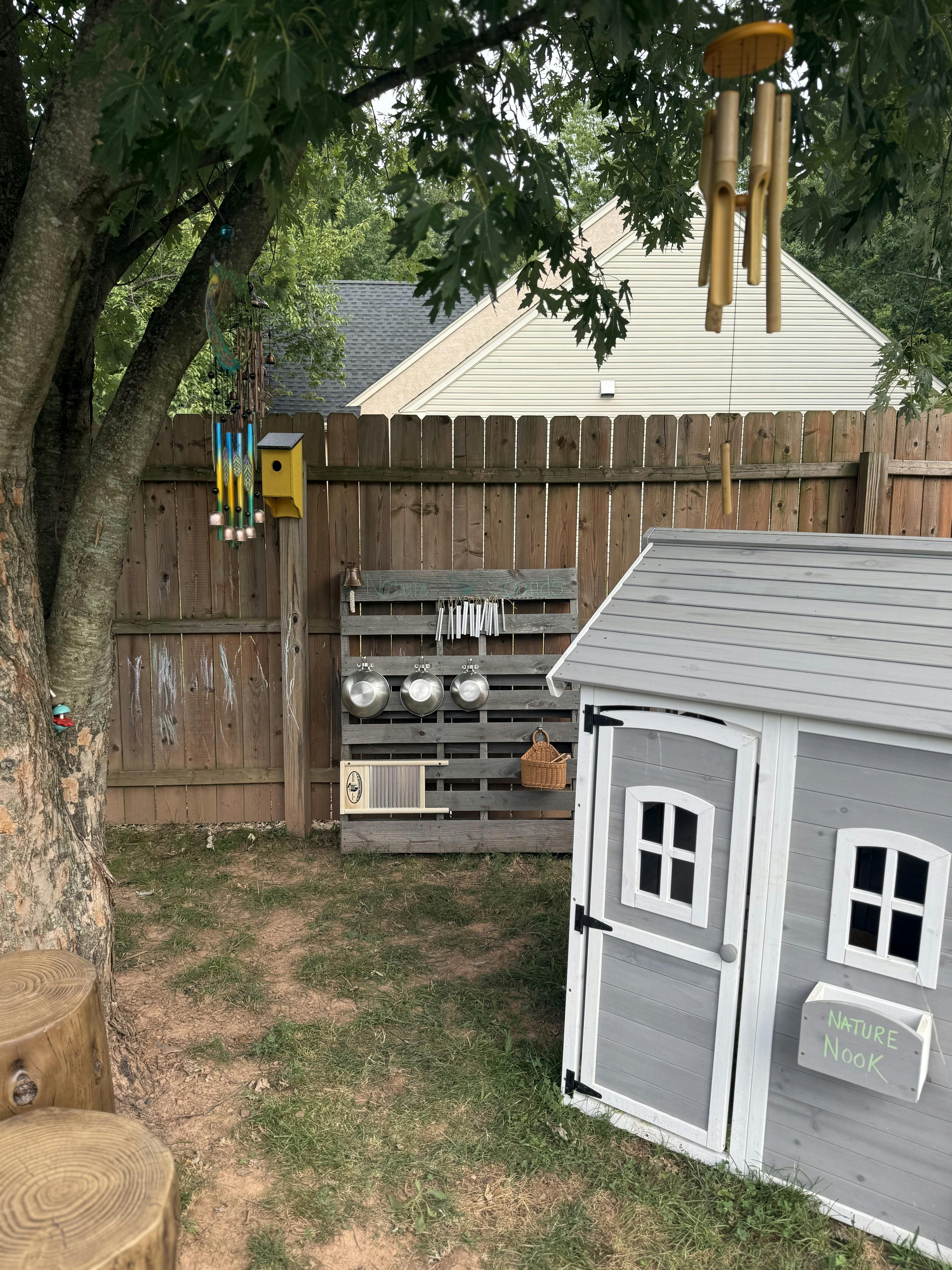 Playhouse and outdoor music station in a backyard