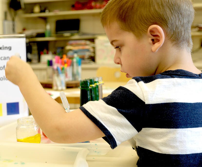 Child looking at a sign with color squares