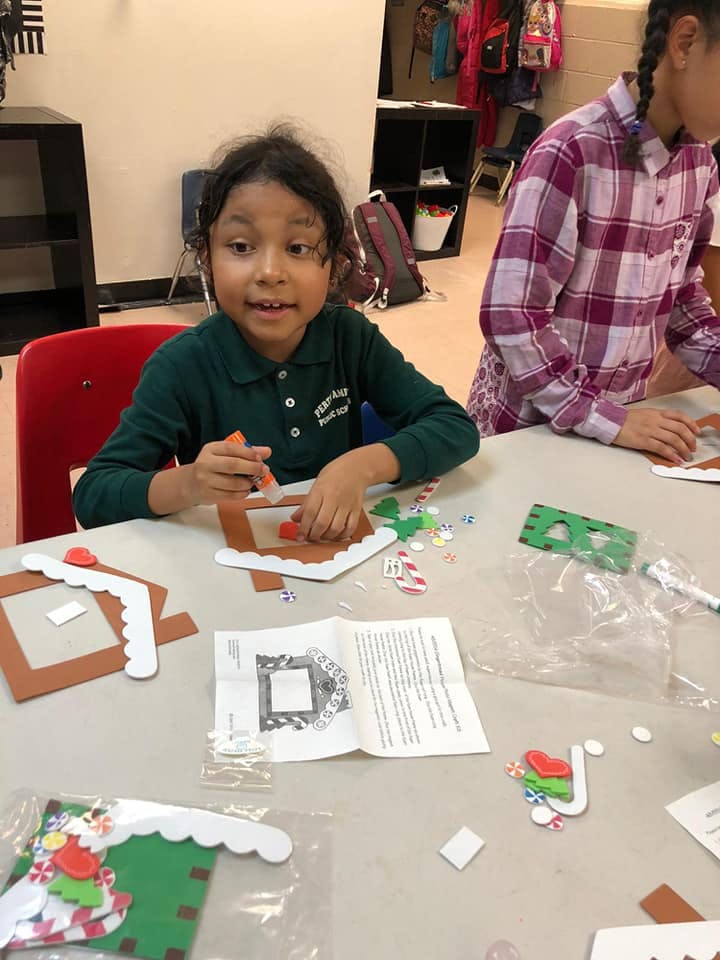 Child making a craft at a table