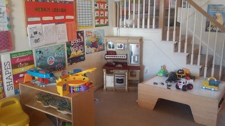 Playroom with toys, play kitchen, and stairs