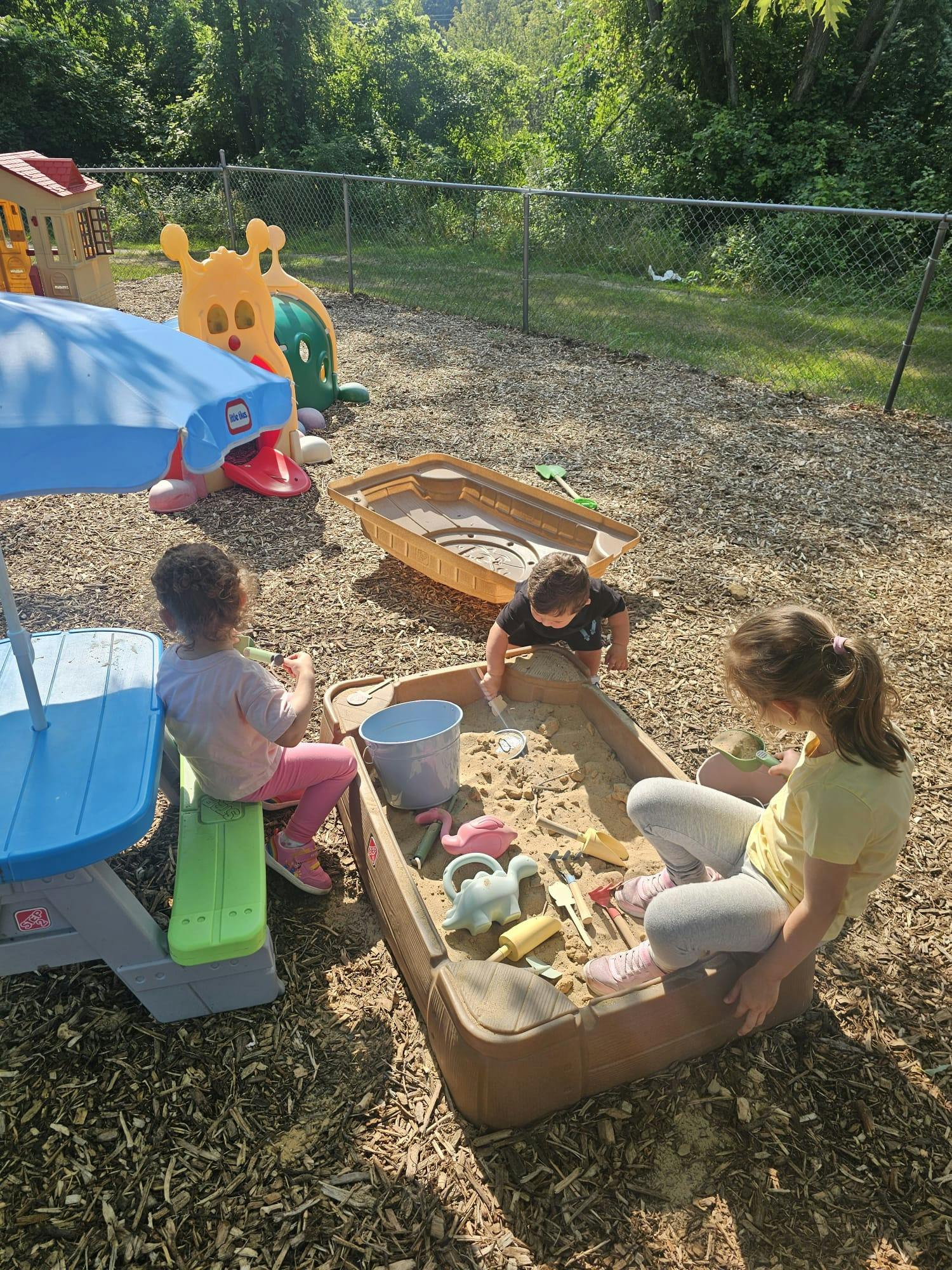 Children playing in a sandbox at a playground