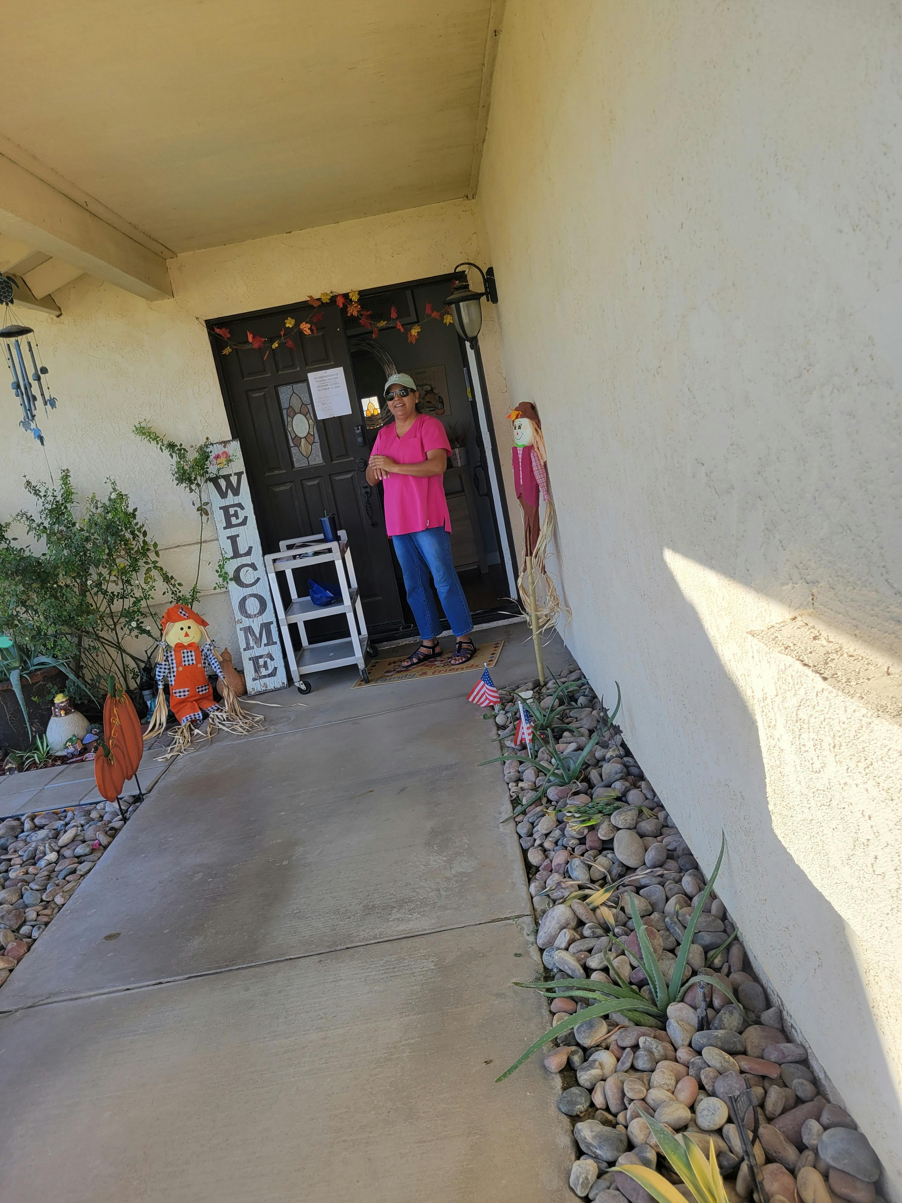 Person standing in a doorway with arms crossed
