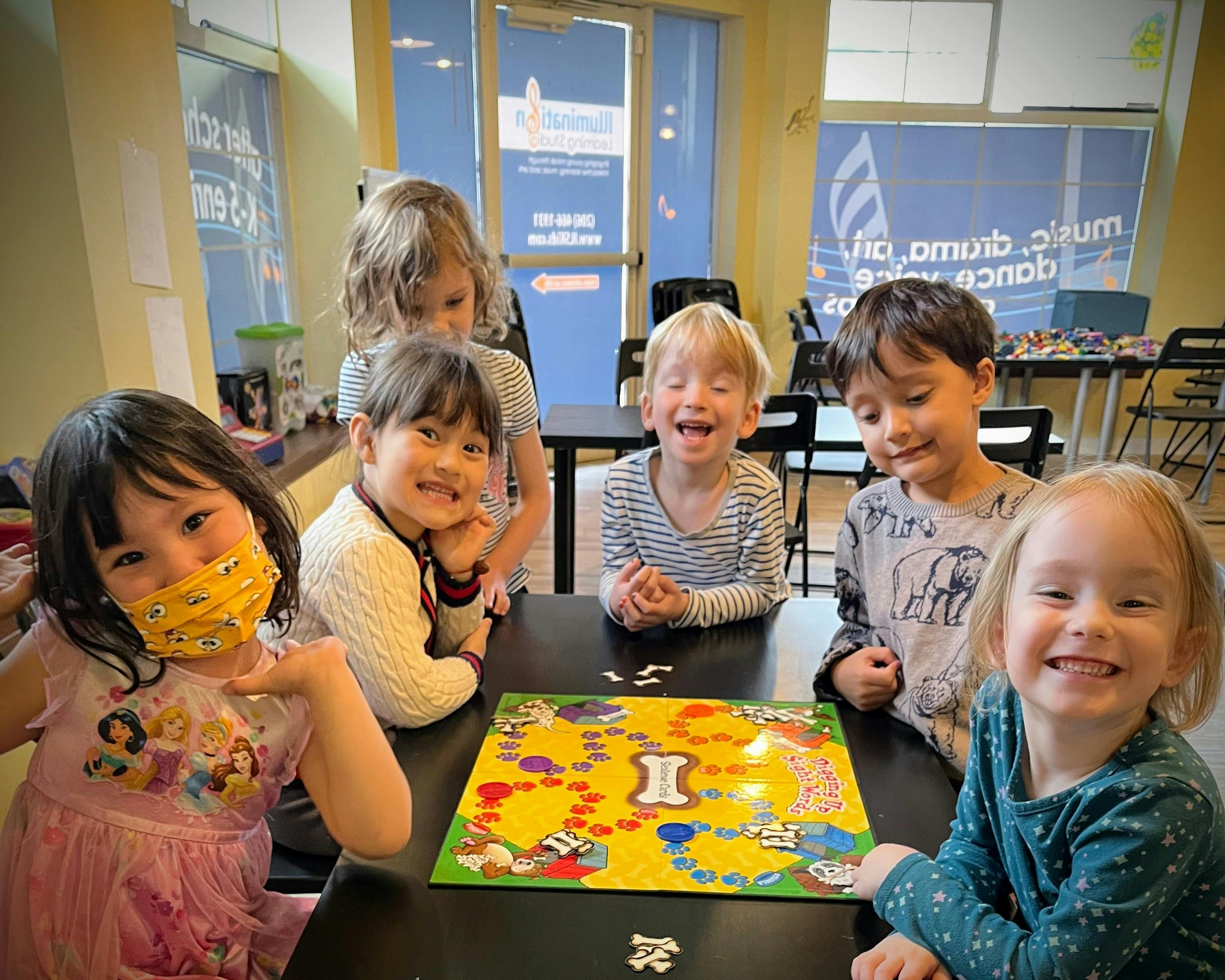 Group of children playing a board game at a table
