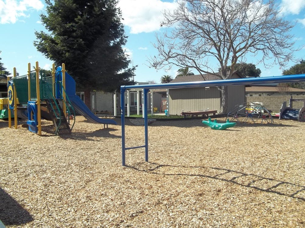 Playground with slide, climbing structure, and monkey bars