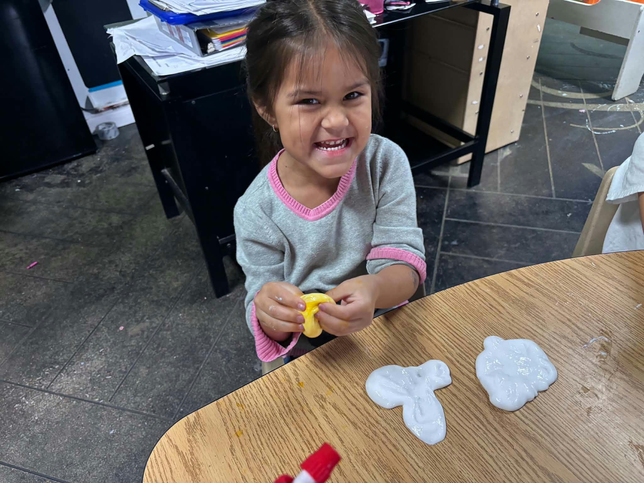 Child playing with slime on a table