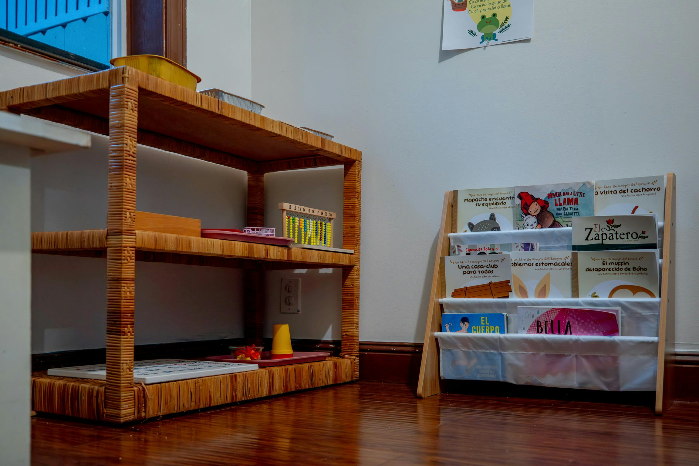 Wooden shelves with learning materials and a book display