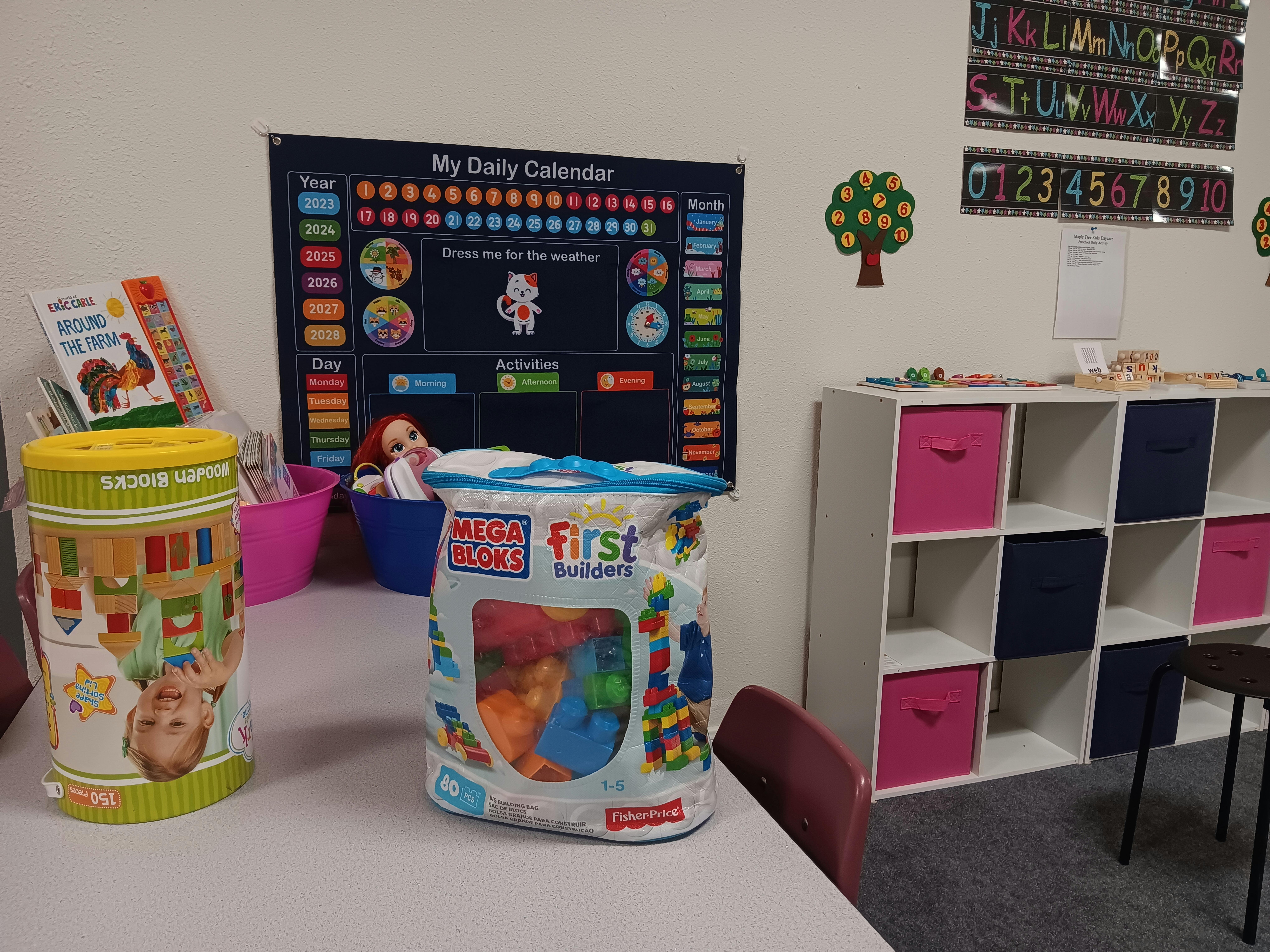 Classroom with a calendar, storage shelves, and toys on a table