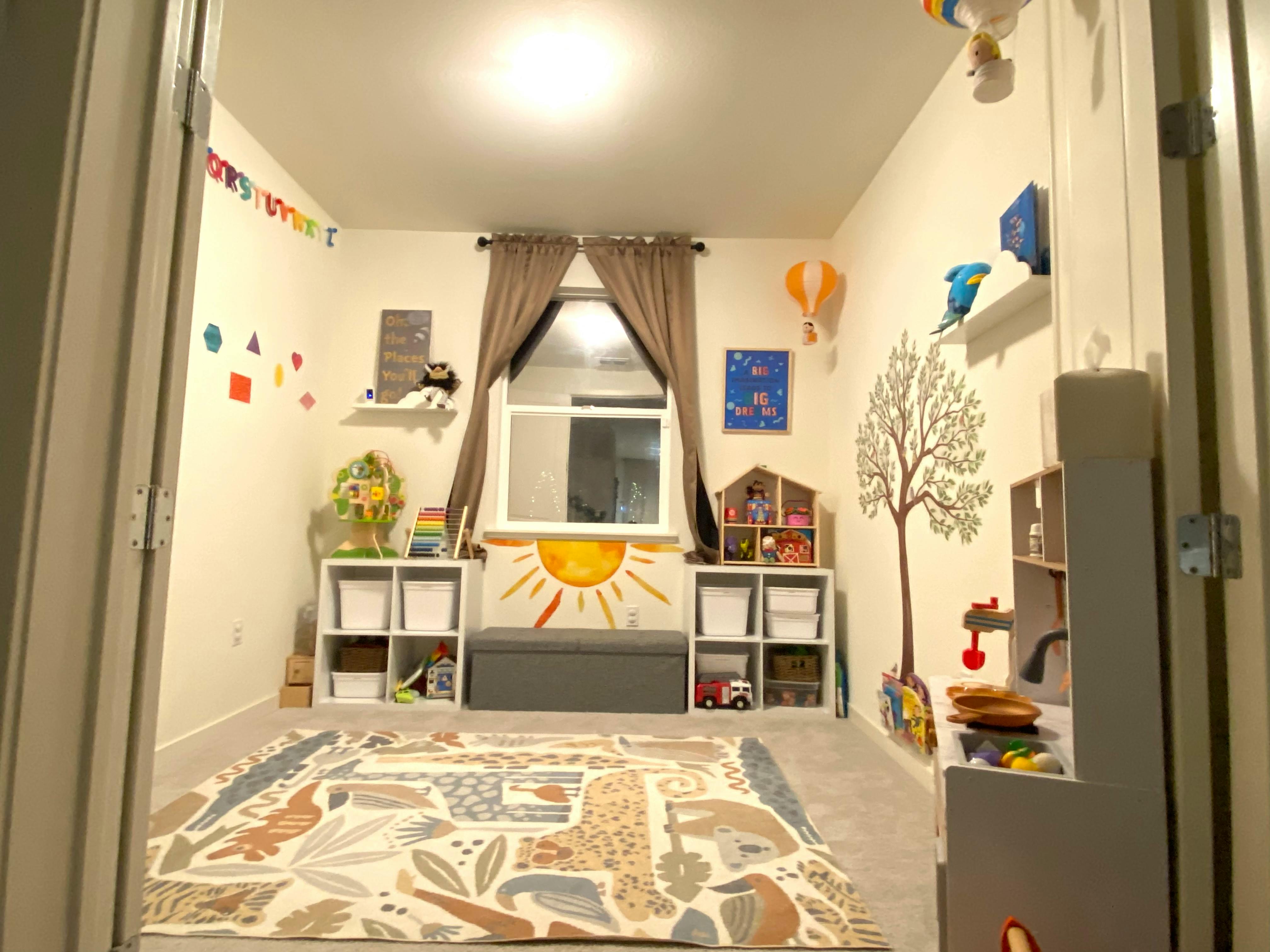 Playroom with a rug, storage shelves, and wall decorations