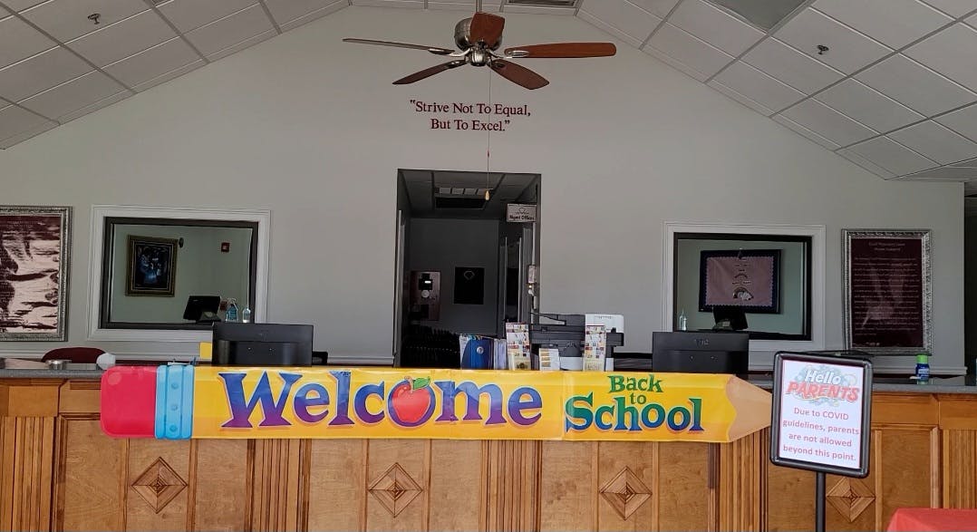 Welcome Back to School sign on a wooden counter