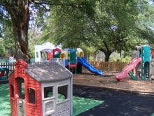 Playground with slides and playhouses under trees