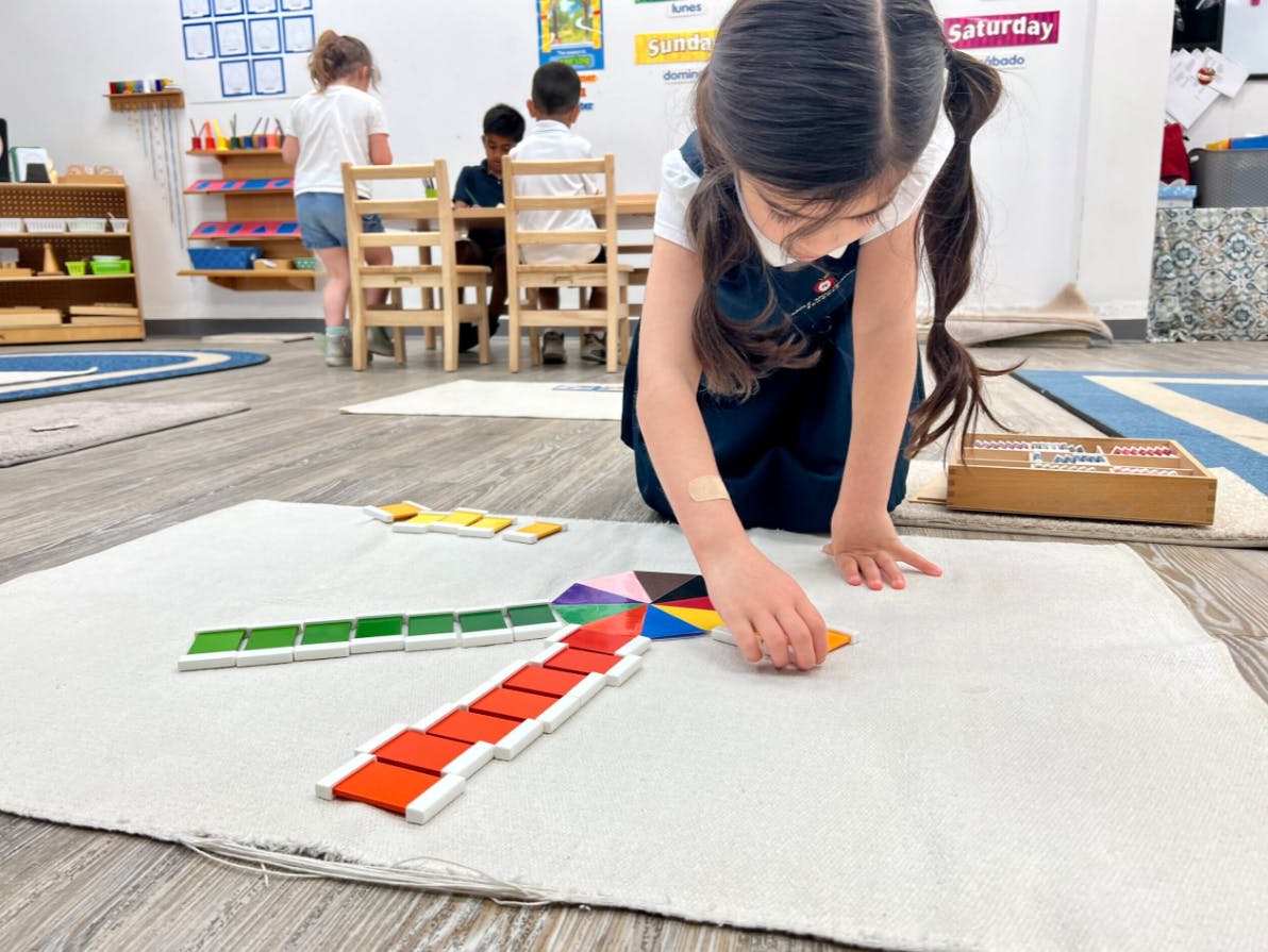 Child on floor playing with colorful learning blocks