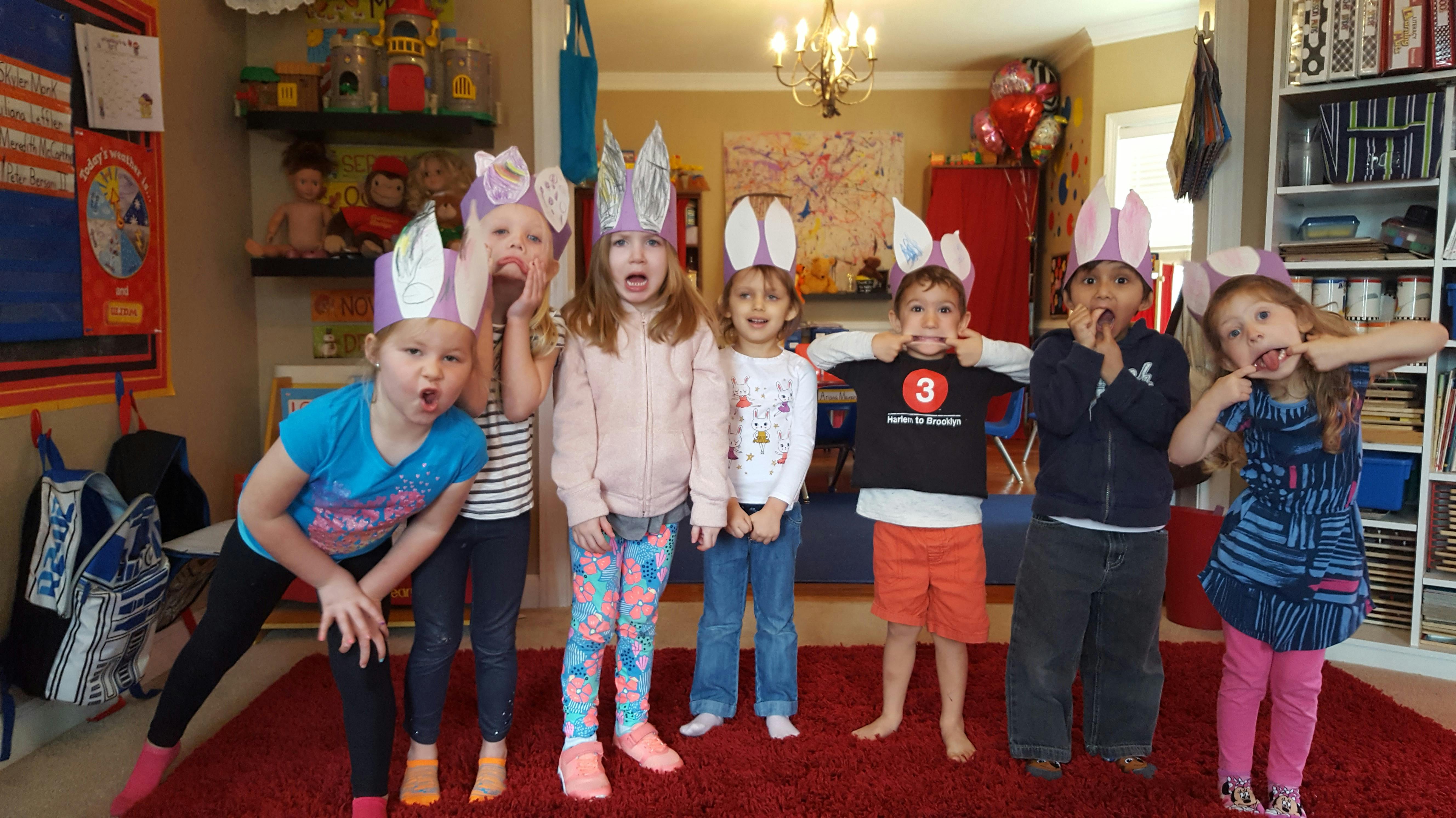 Group of children wearing bunny ears making funny faces