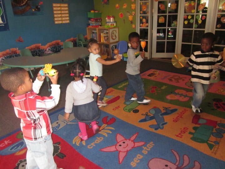 Children playing with musical instruments in a classroom