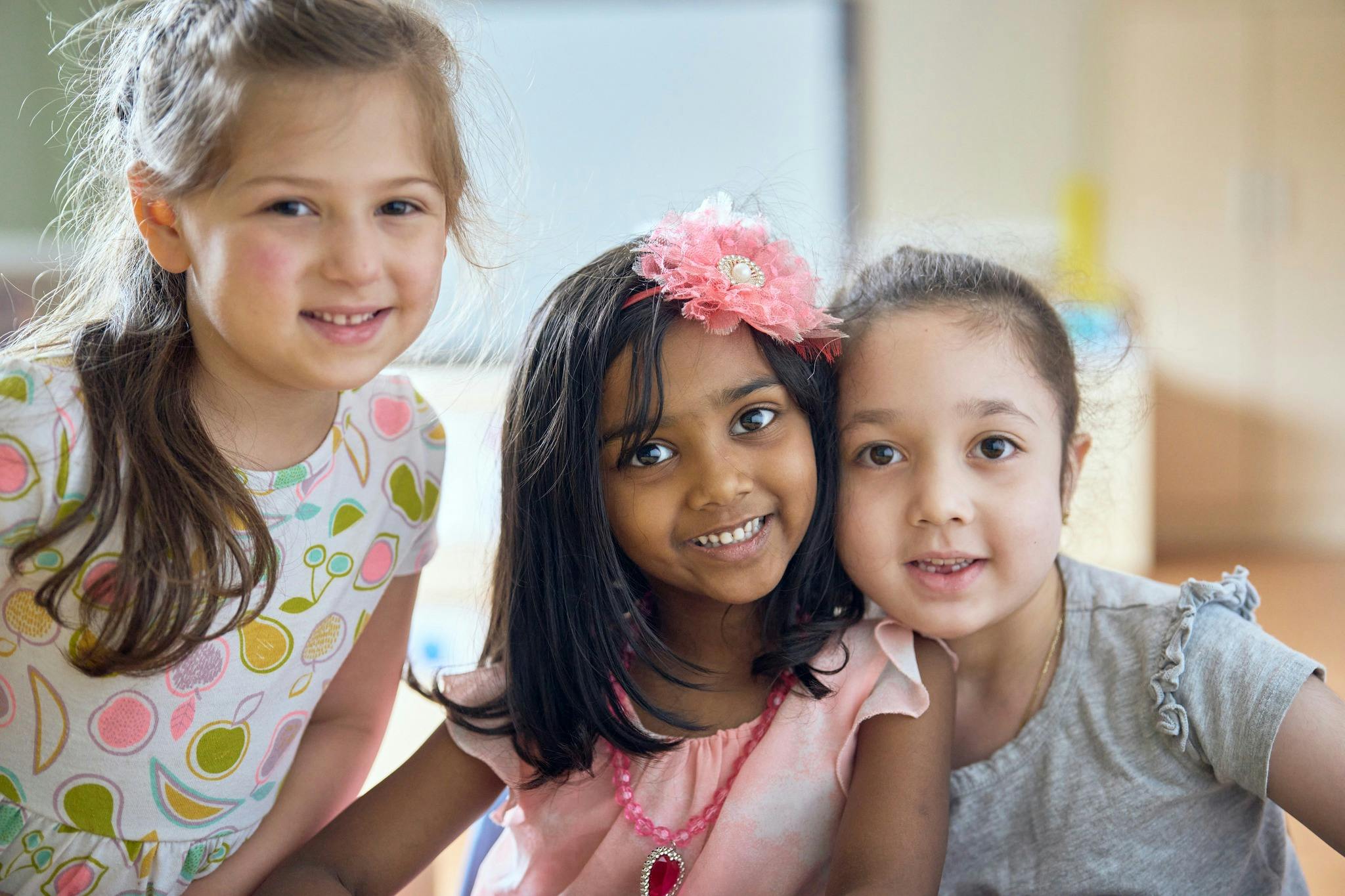 Three children smiling at the camera