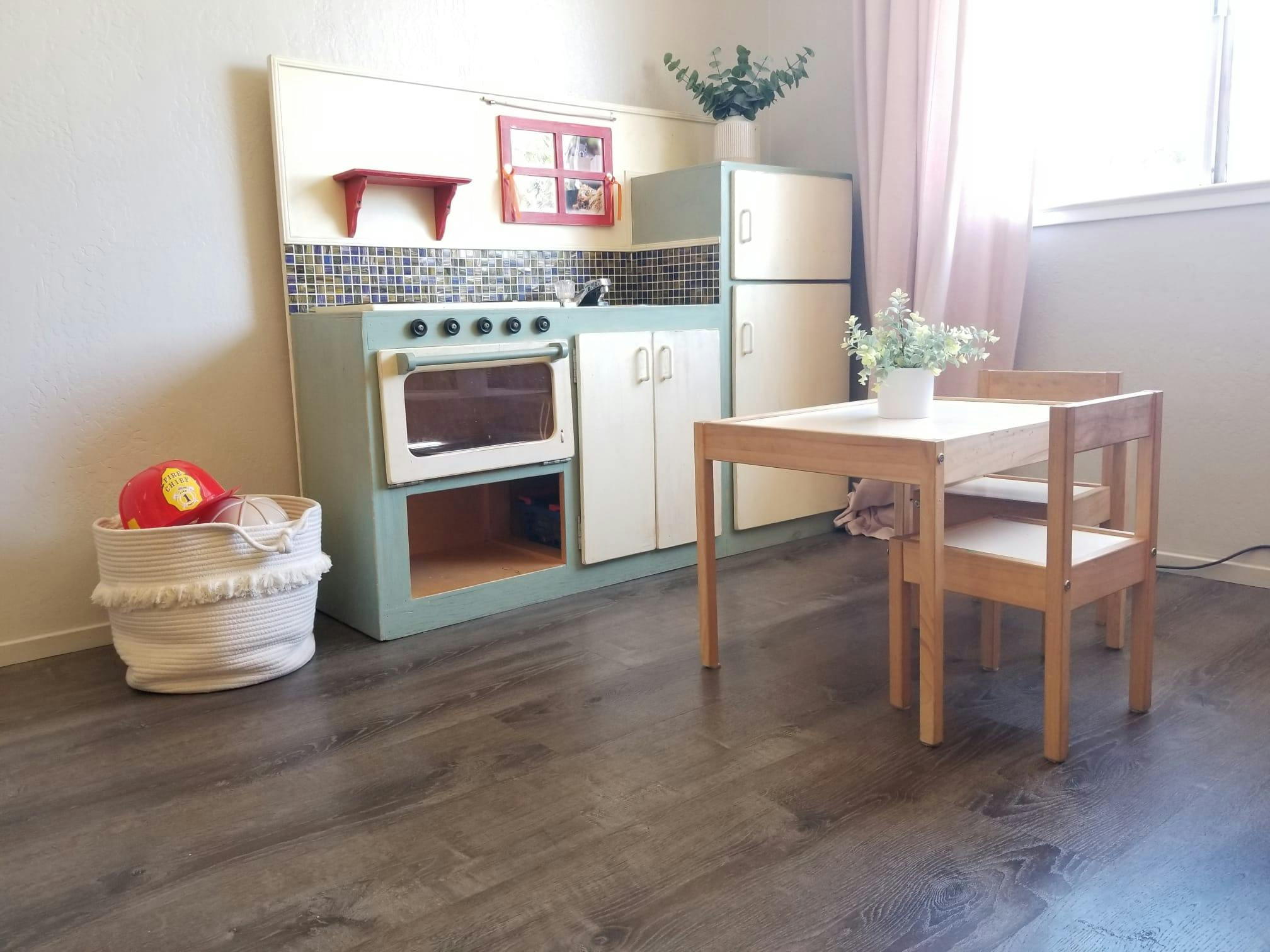 Child's play kitchen with a small table and chairs