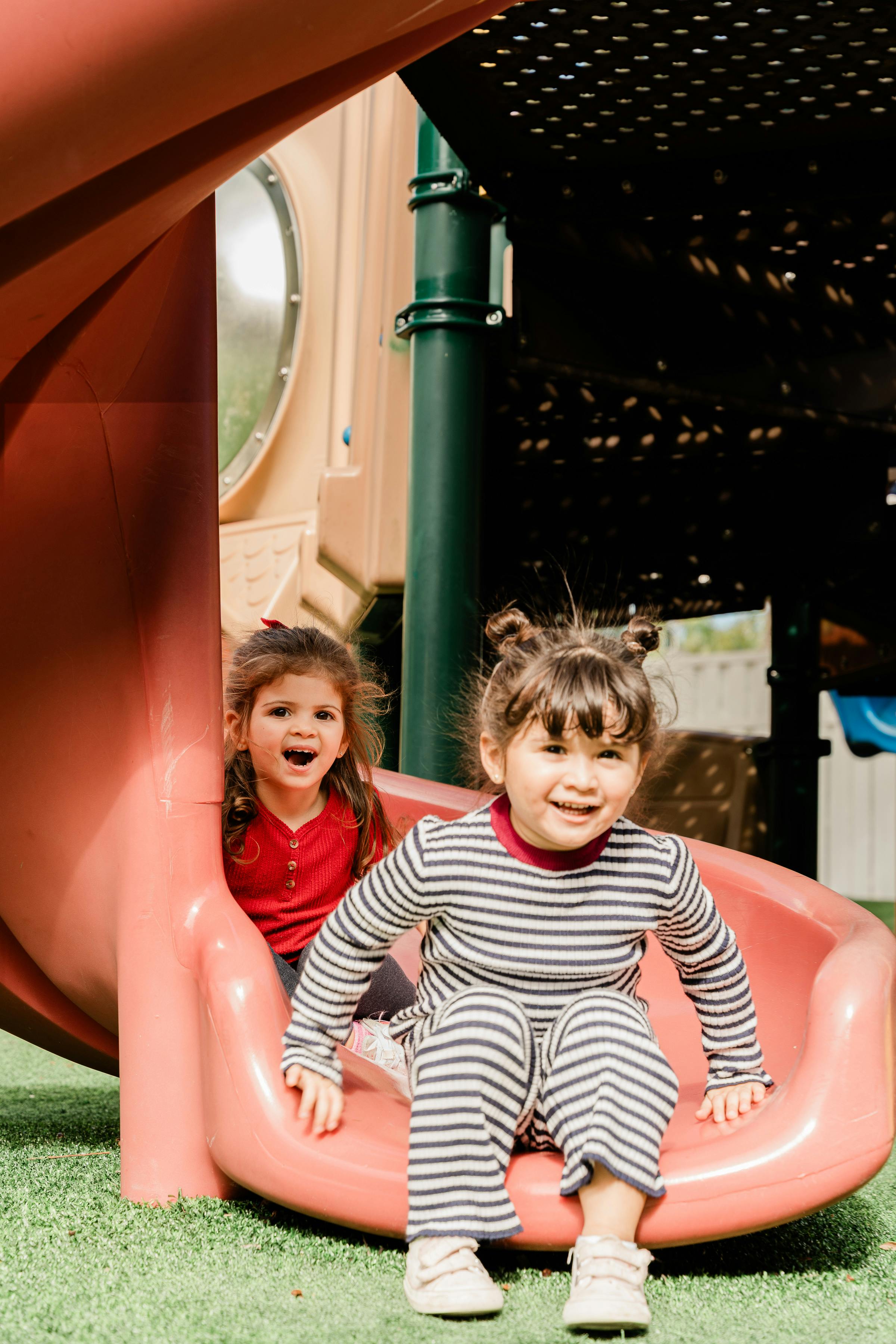 Two children on a playground slide